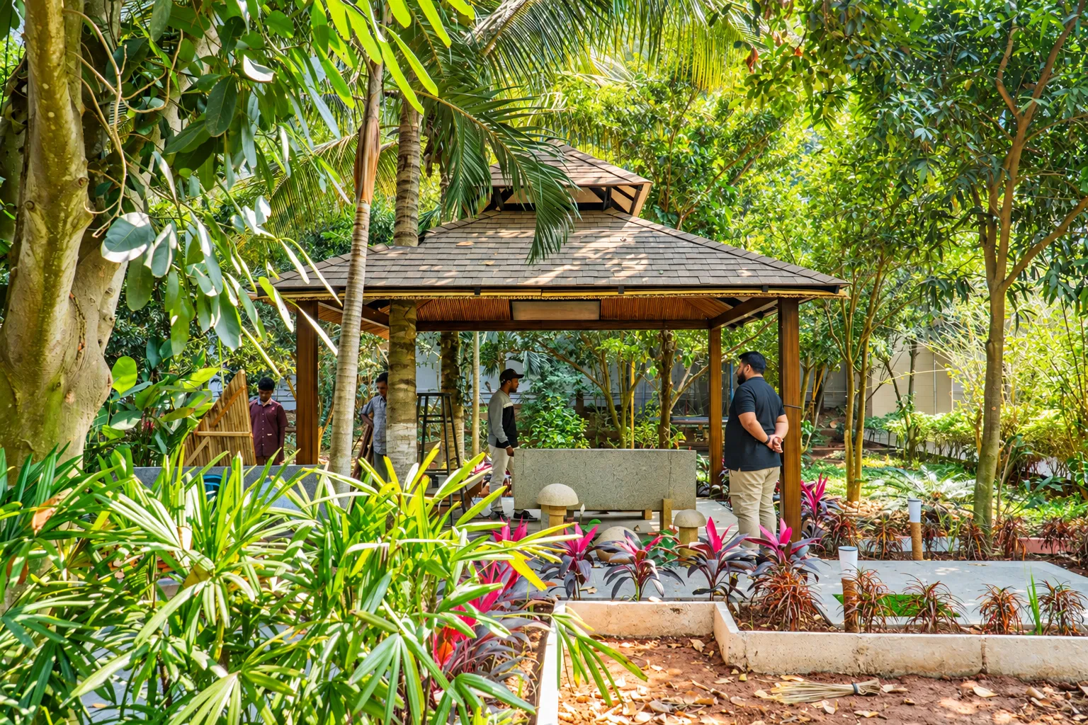 Completed shingle-roof garden gazebo surrounded by tropical planting