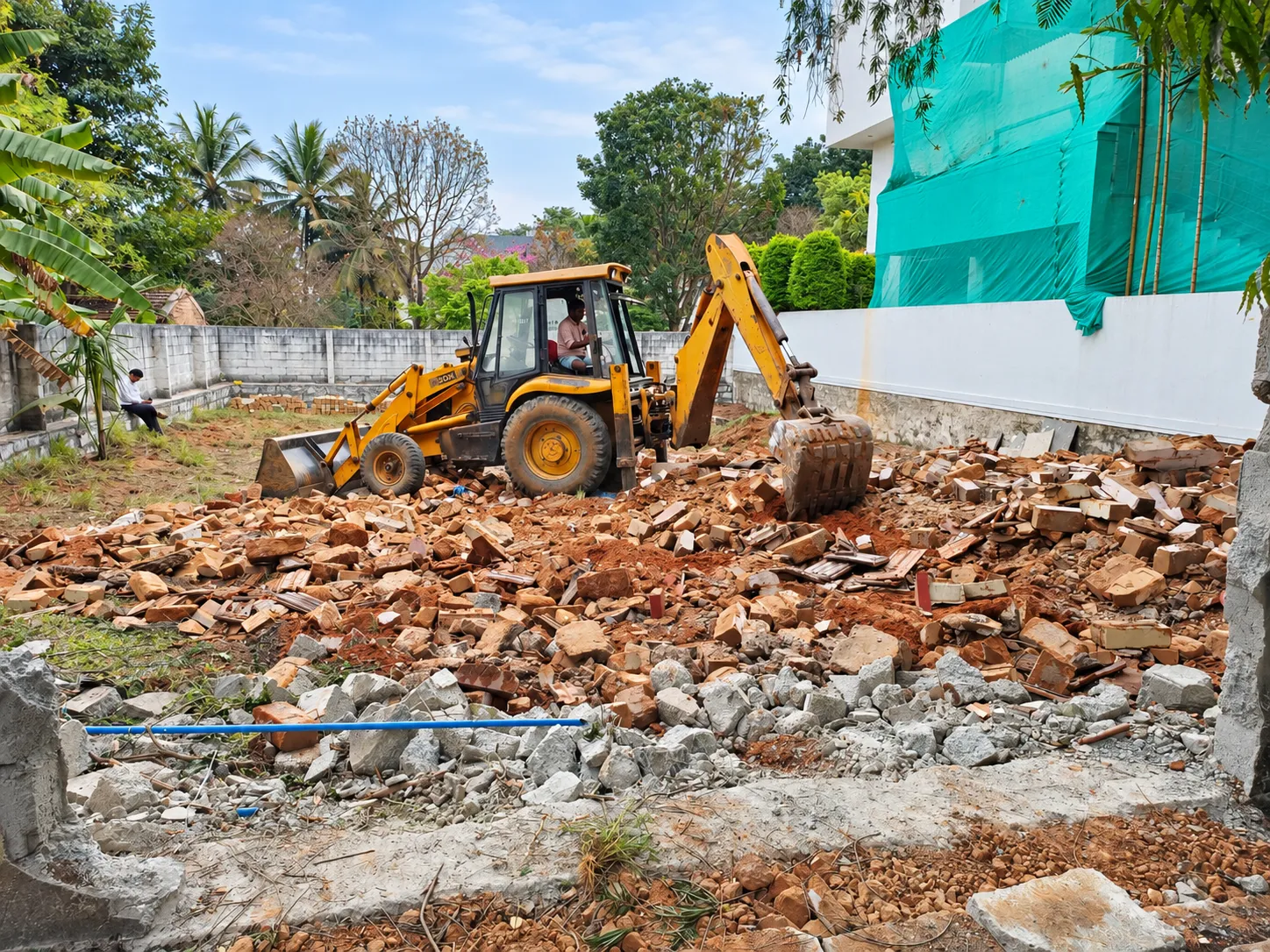Groundwork and site preparation with an excavator before fabrication and landscaping
