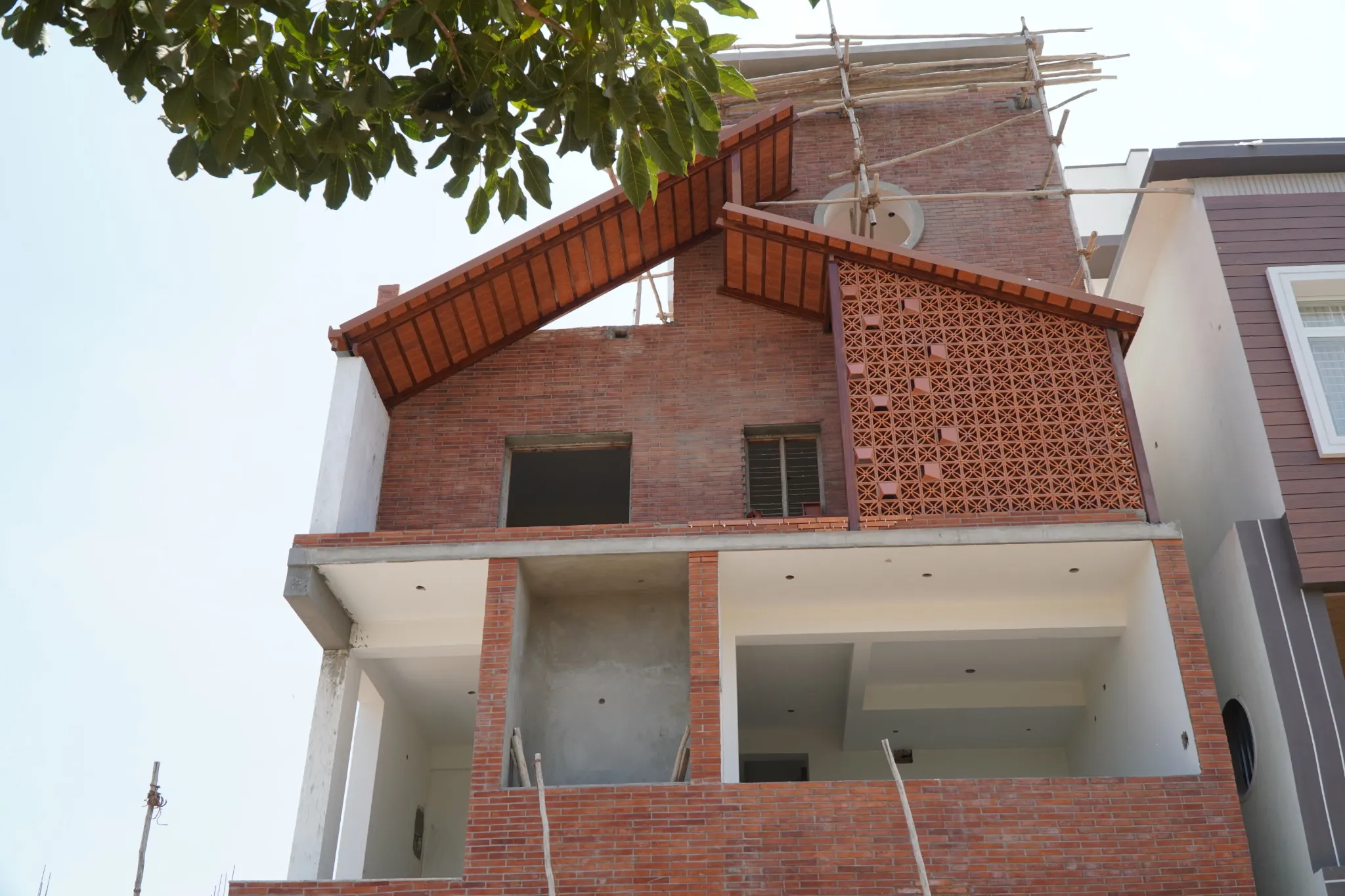 Mangalore tile roof and terracotta jali screen on a building exterior
