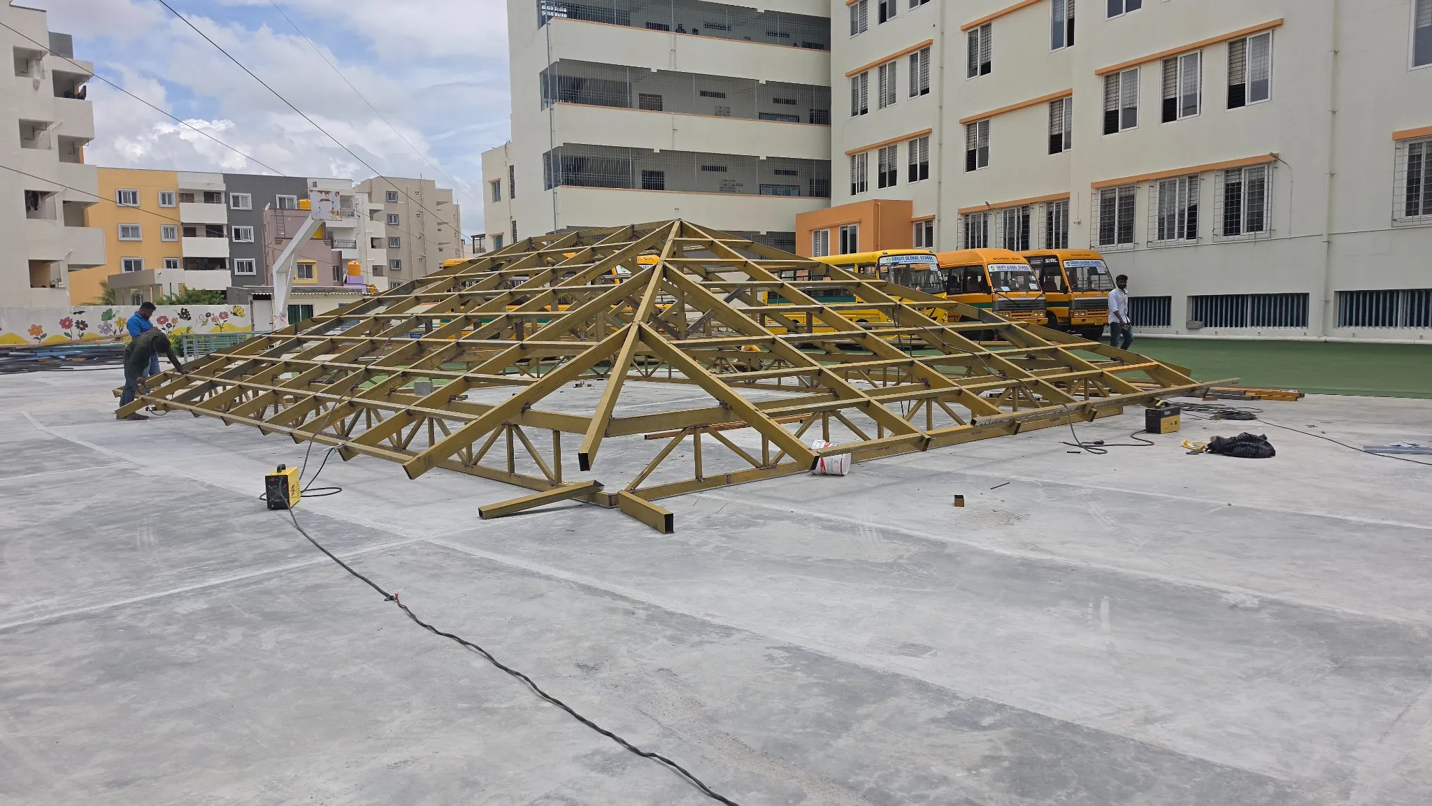 Roof trusses being assembled on a large terrace