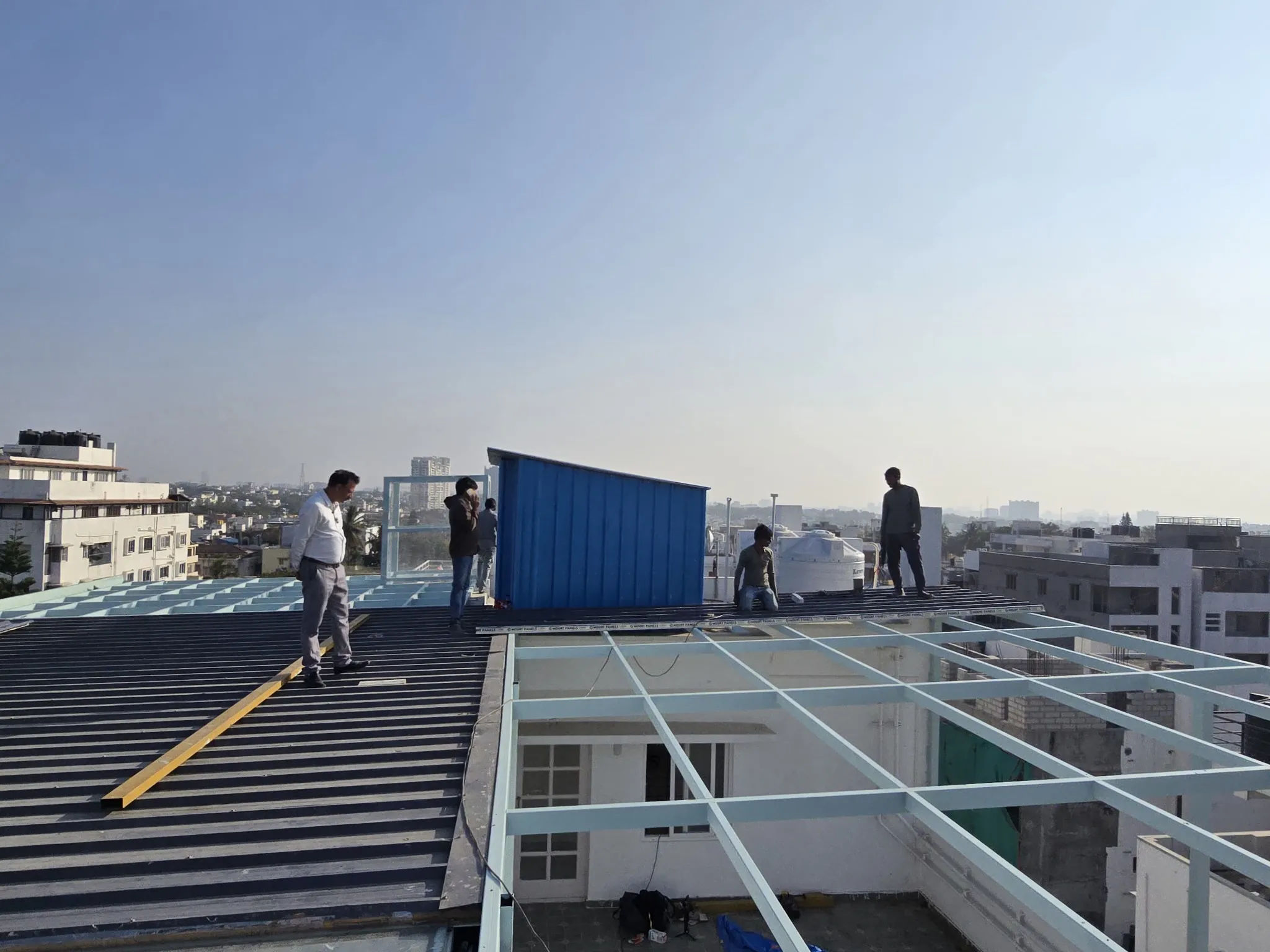 Installation team working on a rooftop steel framework