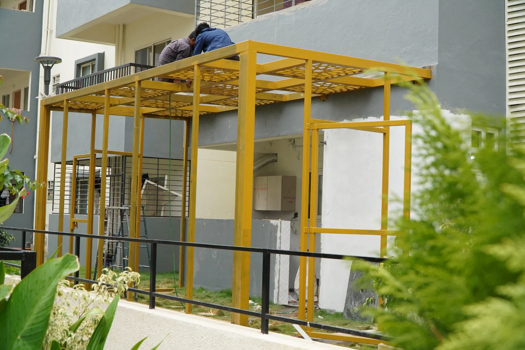 Steel frame installation around an outdoor seating area