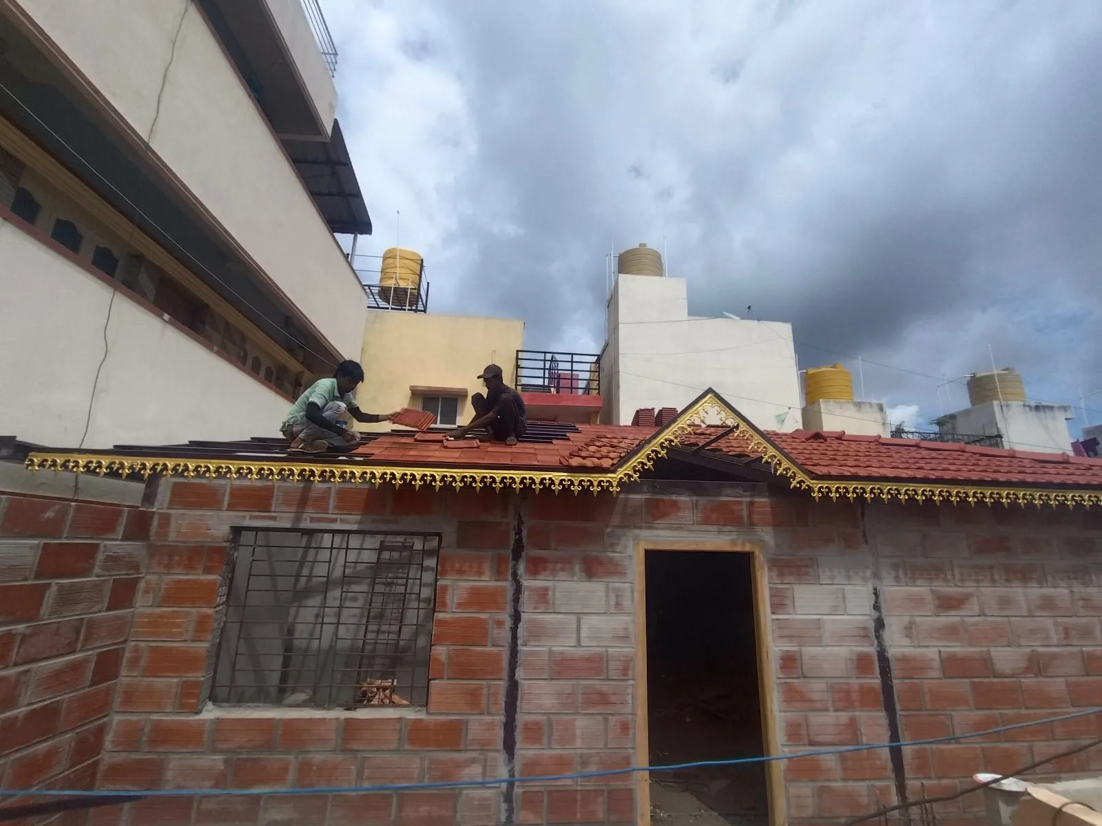 Roof installation in progress on a brick building