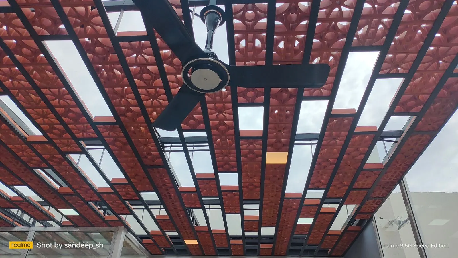 View beneath a roof combining Mangalore tiles and glass panels