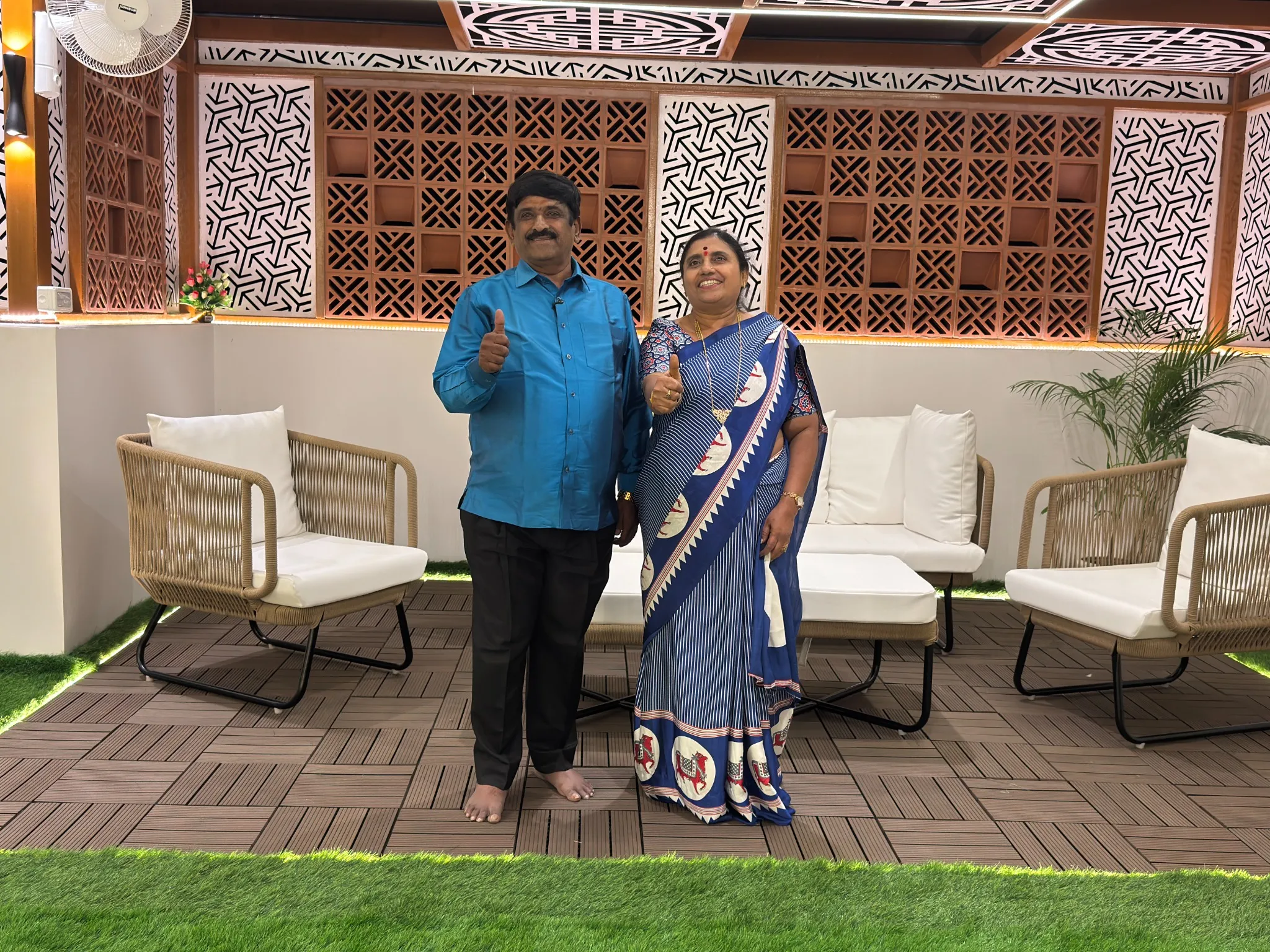 Customers standing in a completed outdoor seating area with decorative privacy screens