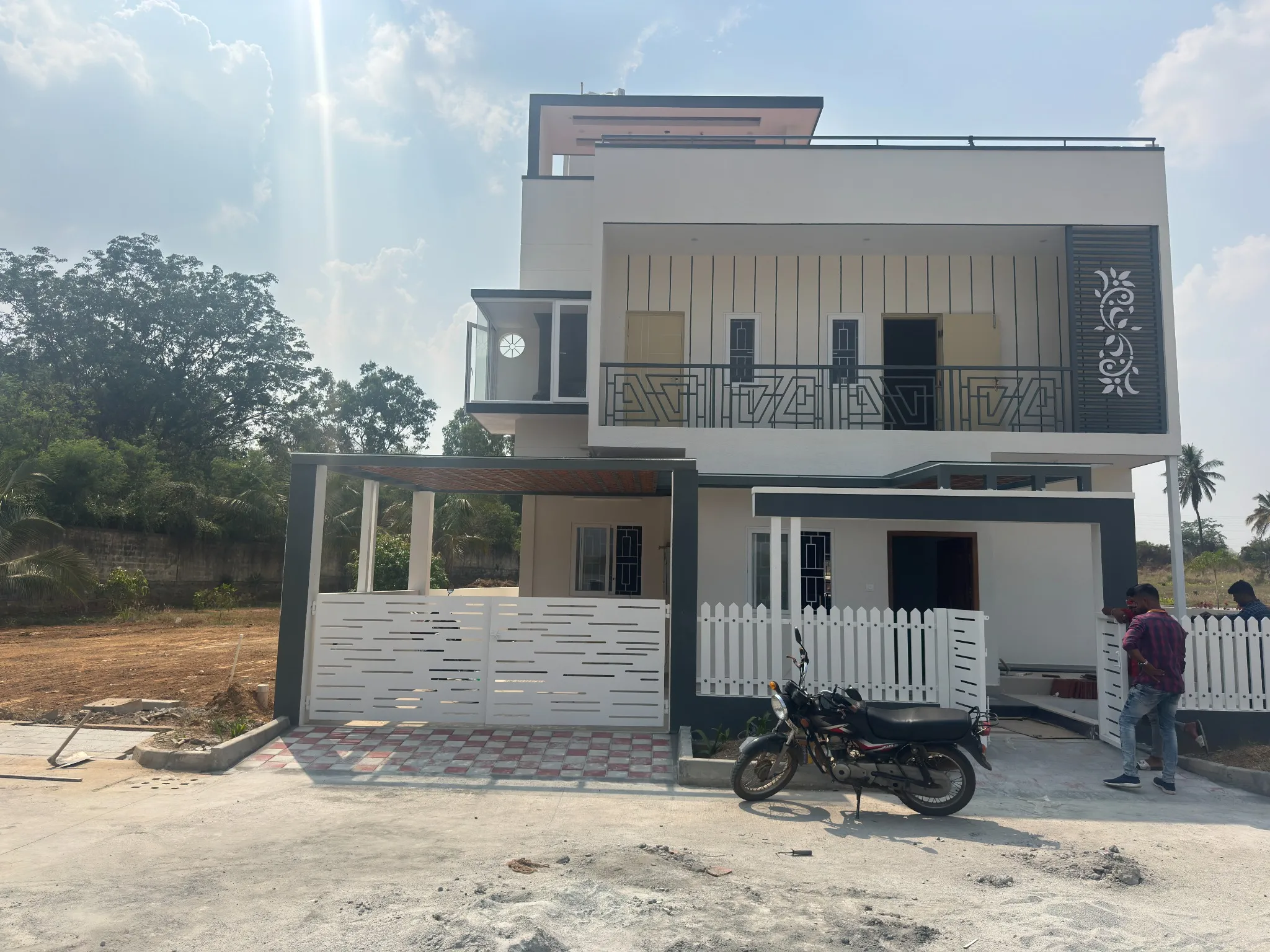 House exterior with a covered entrance, balcony railings and front gate