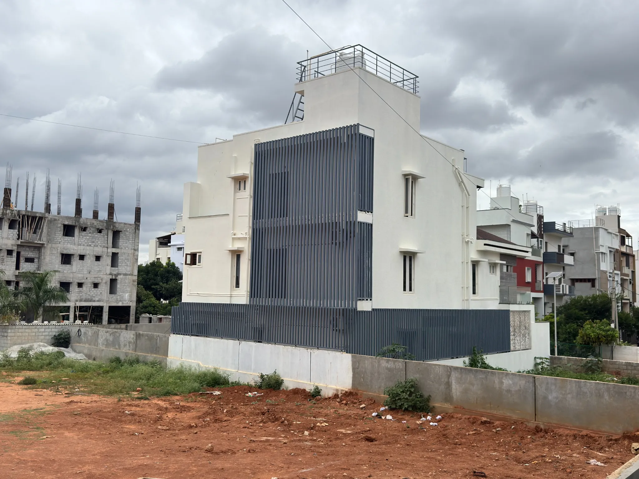 House exterior with metal facade panels and rooftop structures