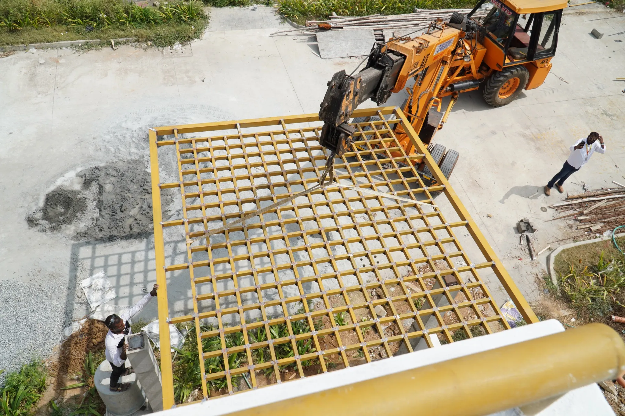 Fabricated metal roof frame being lifted during installation
