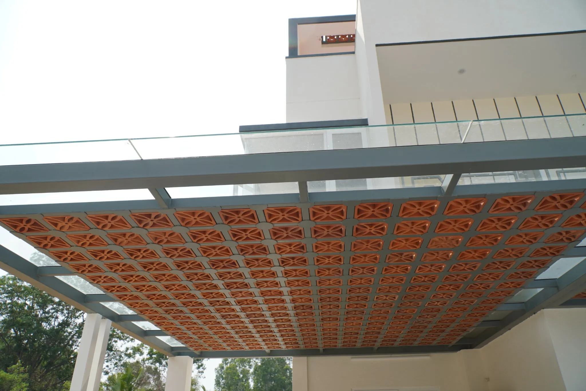 Decorative terracotta screen panels fitted into an overhead steel framework