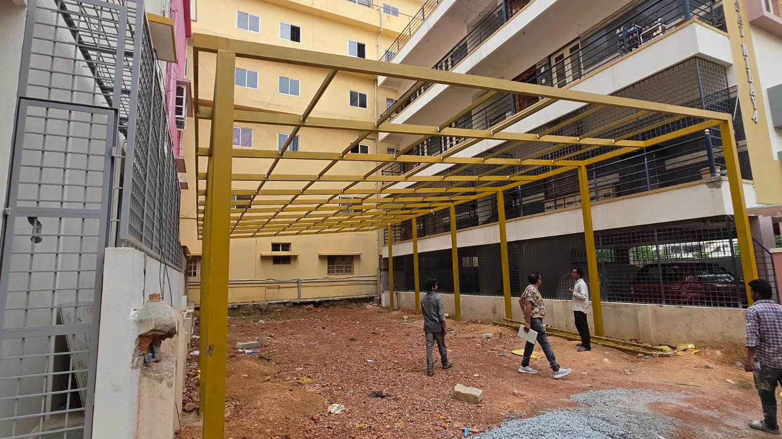 Large steel canopy framework under construction between buildings