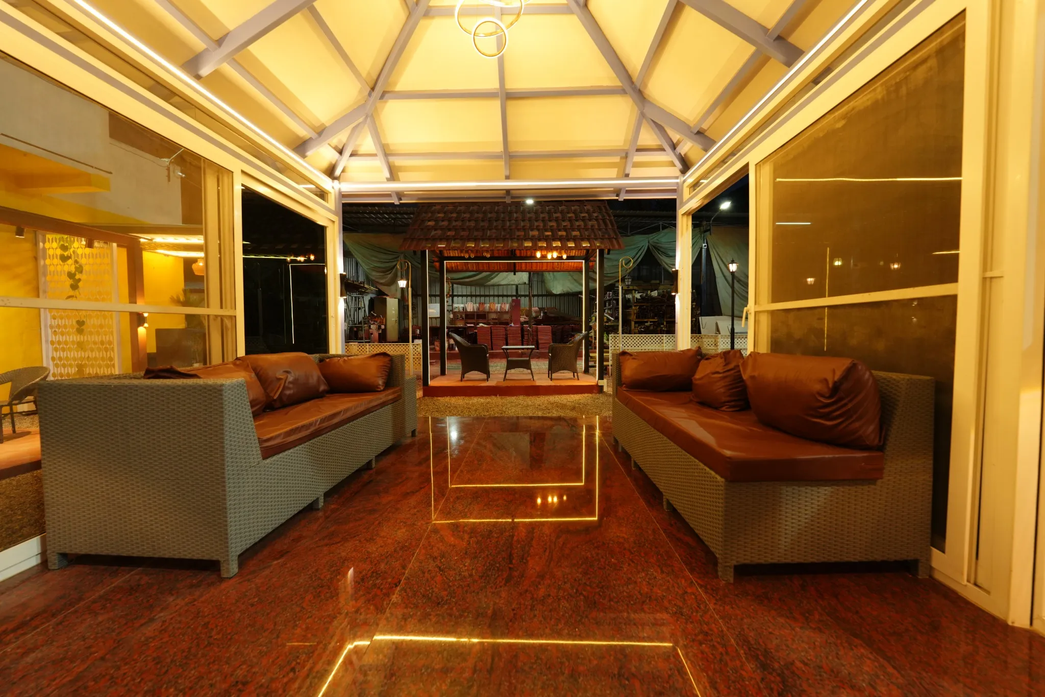 Illuminated enclosed seating area with glass roof panels