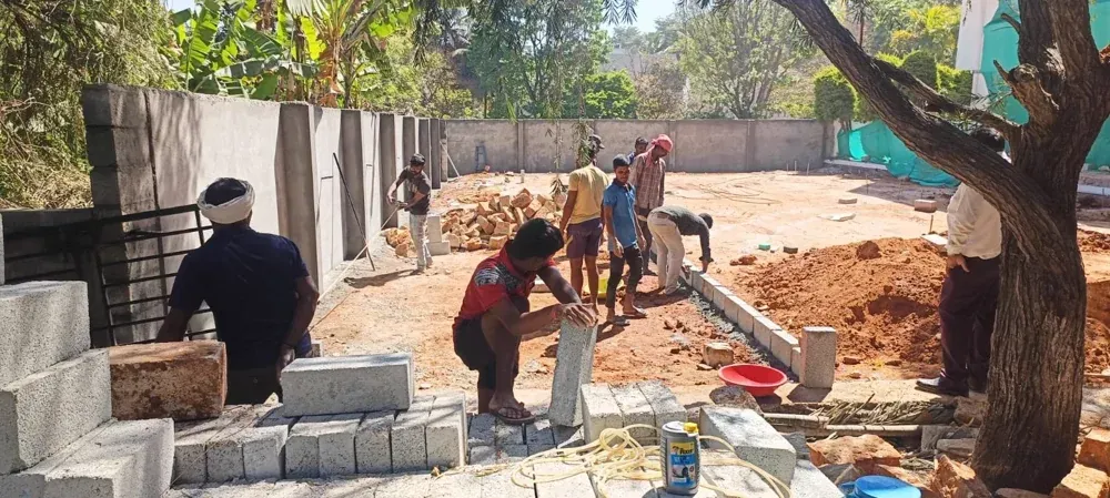 The team builds the masonry edges that define the outdoor layout.