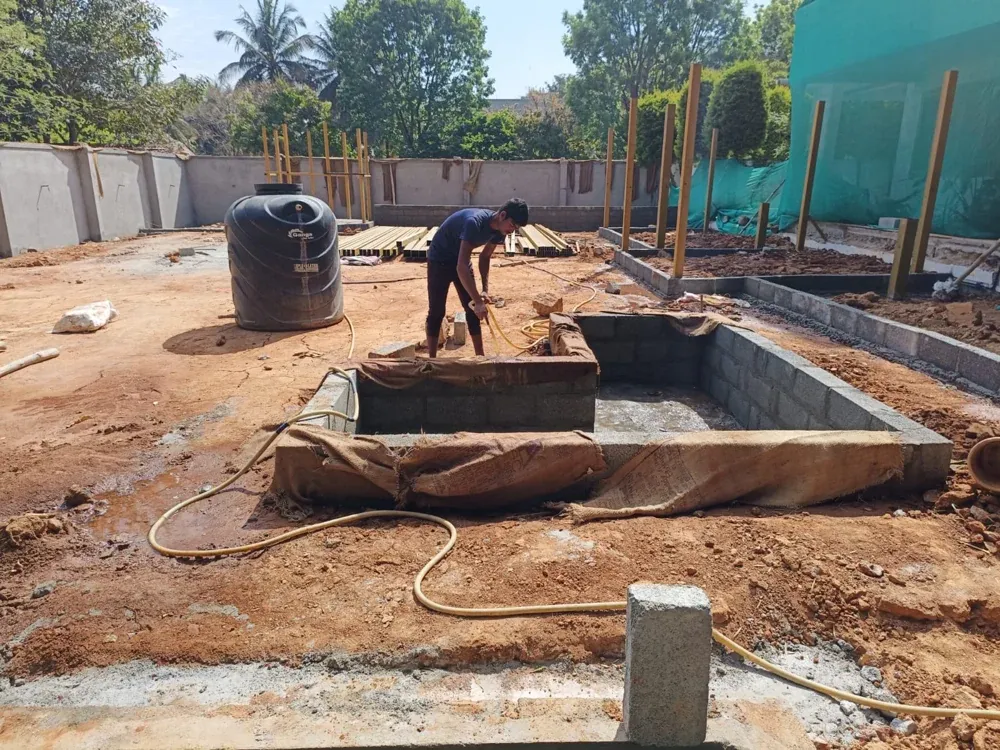Masonry work forms the garden water feature and surrounding levels.