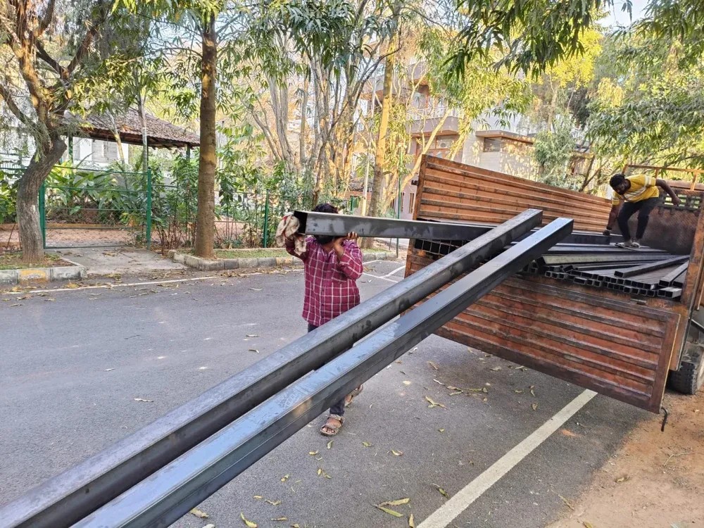 Steel sections are unloaded for the fabrication work.