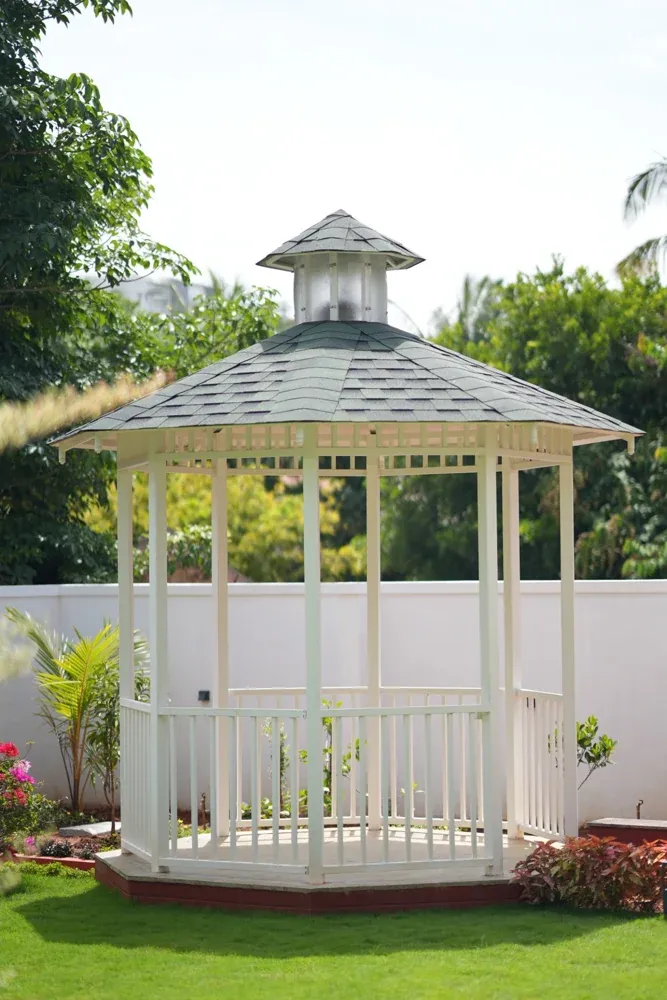 The white gazebo creates a separate sheltered spot within the landscape.