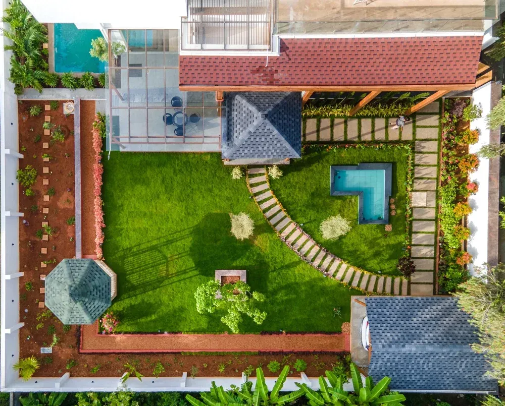 An overhead view shows how the lawn, paths, water feature and covered spaces connect.