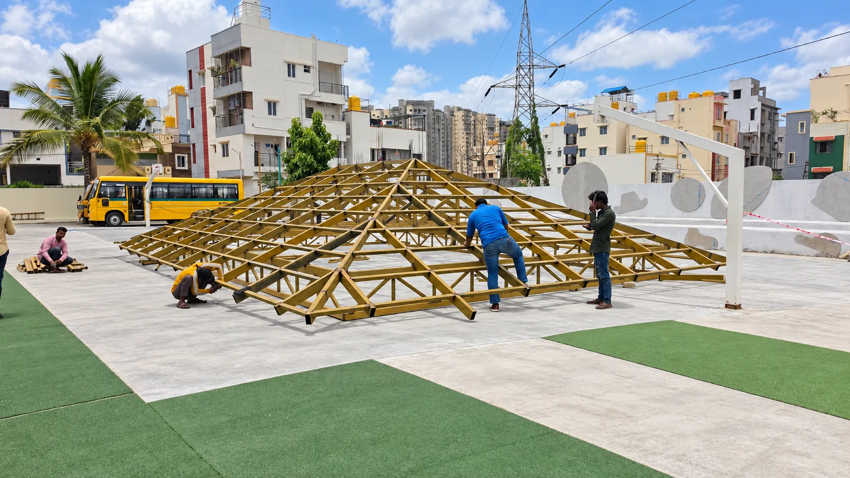 Team members assembling a custom steel roof framework before installation