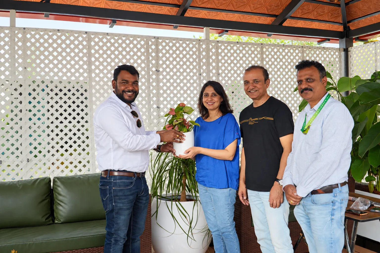 Customers and the Pergola Design.in team at a handover beneath a Mangalore tile pergola