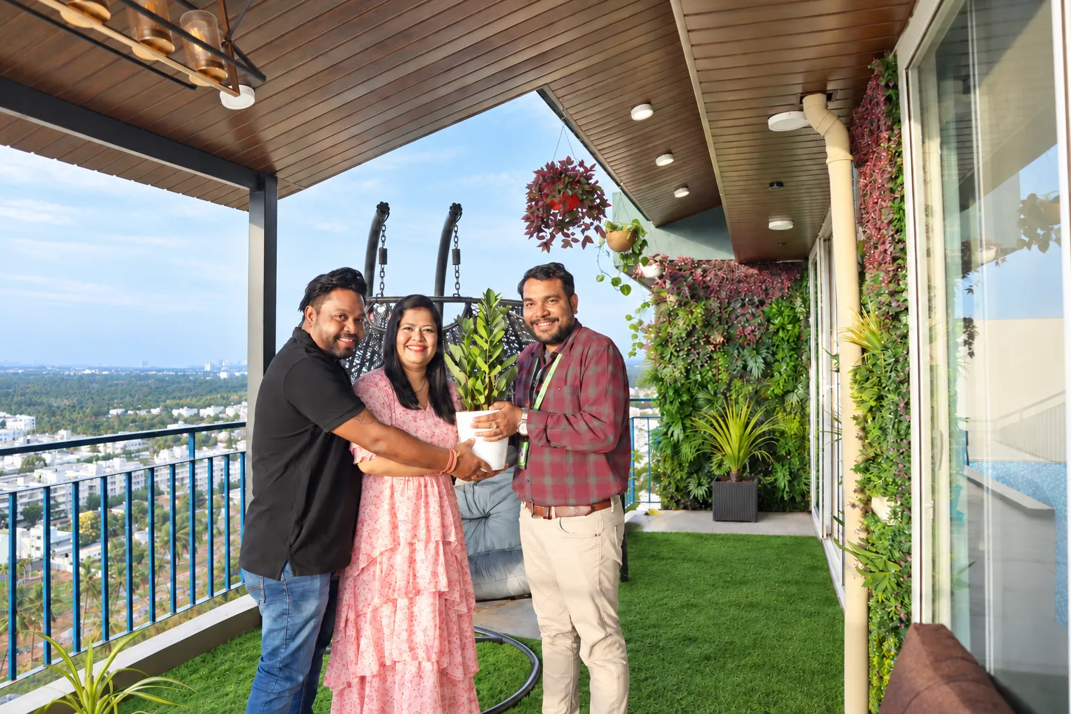 Sameer and family with the Pergola Design.in team beneath their finished terrace pergola