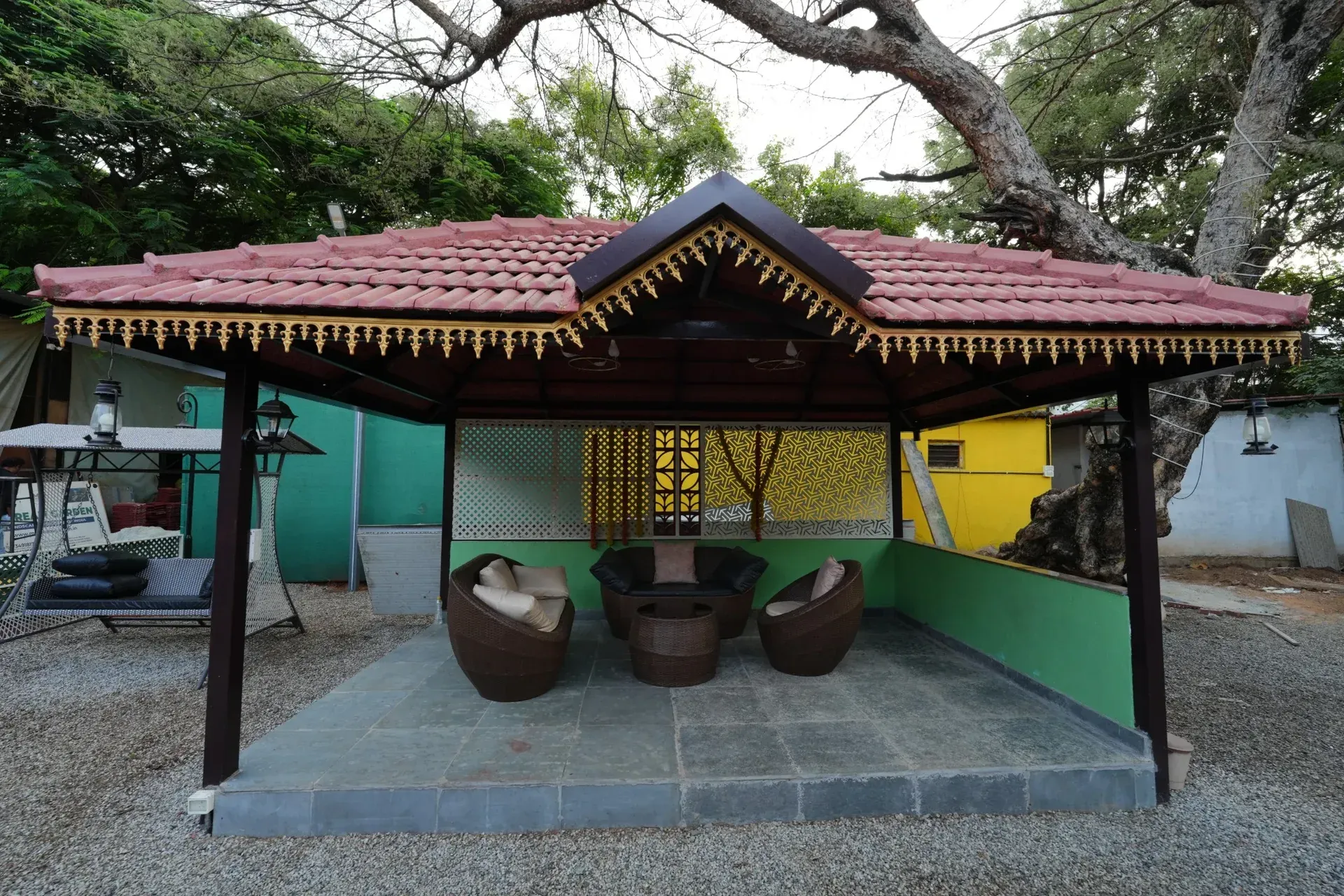 Mangalore tile gazebo with seating and decorative privacy screens