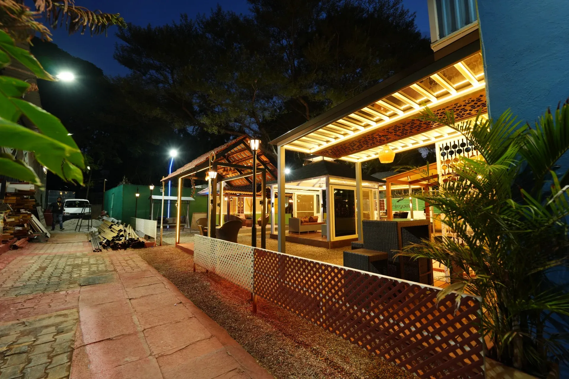 Evening walkway alongside the illuminated premium pergola displays