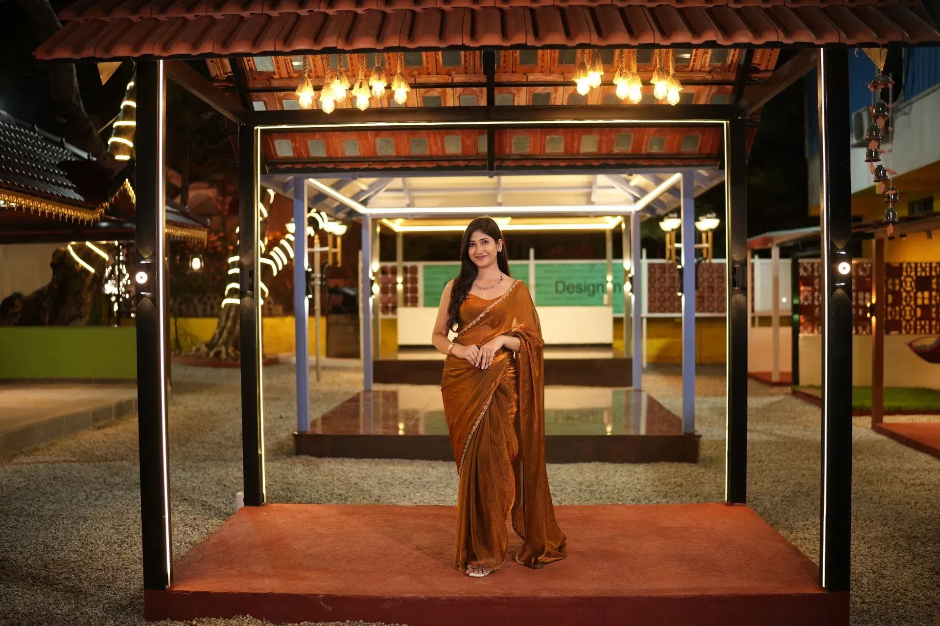 A visitor beneath the illuminated Premium Mangalore tile pergola display