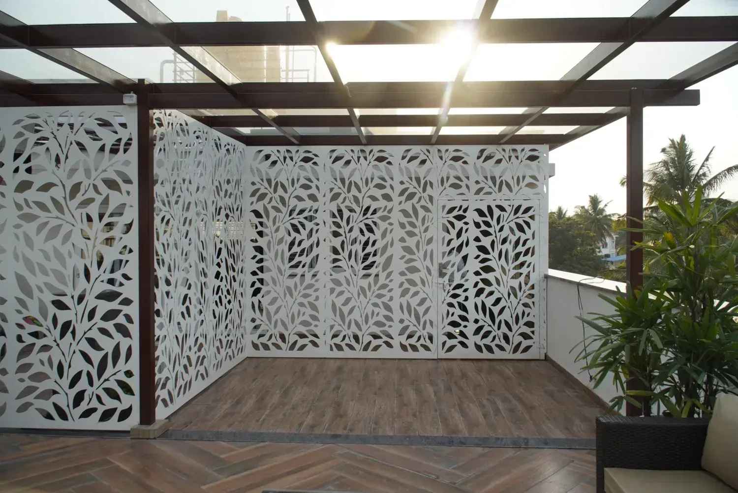 Glass-roof pergola with decorative privacy panels