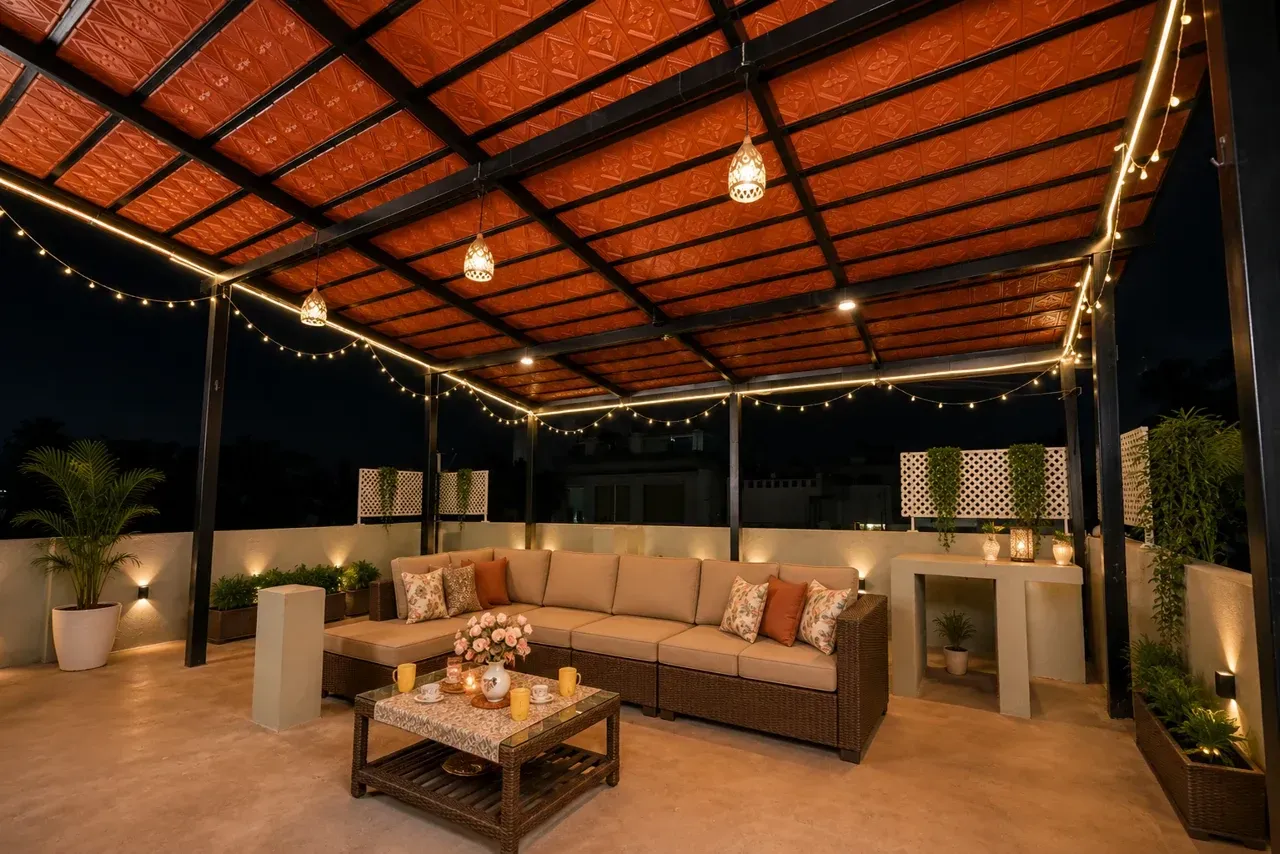 Enhanced evening terrace view with terracotta roof tiles, a sofa and illuminated planters