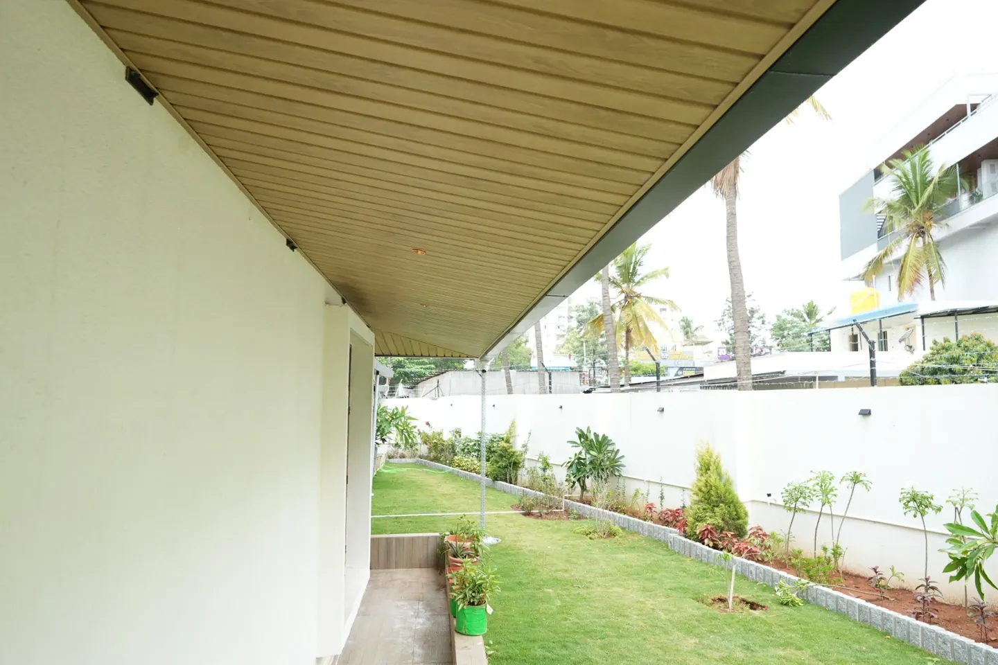 View along the timber-toned canopy ceiling beside the villa garden