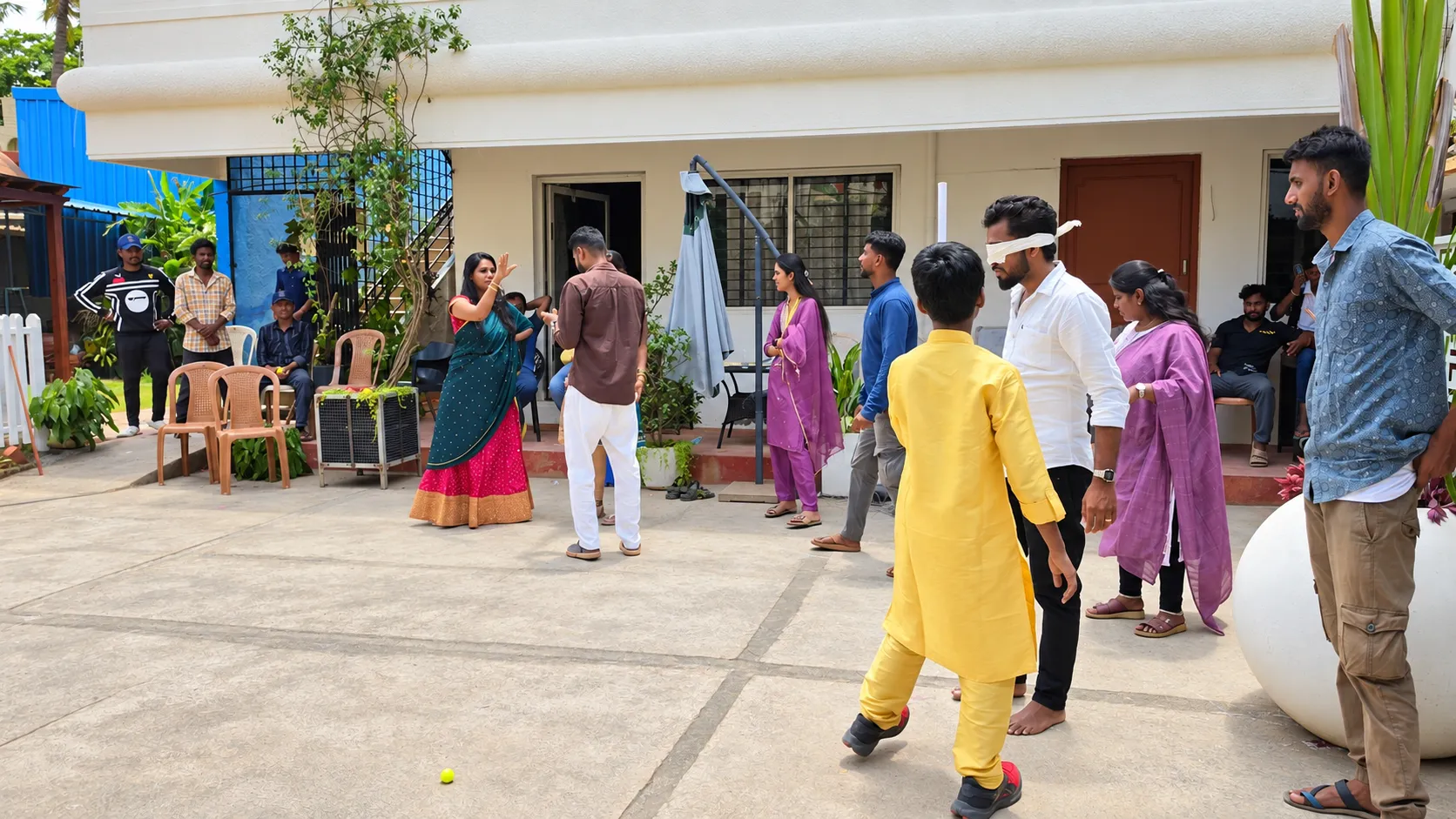 A group enjoying an outdoor blindfold game during a Pergola Design.in celebration