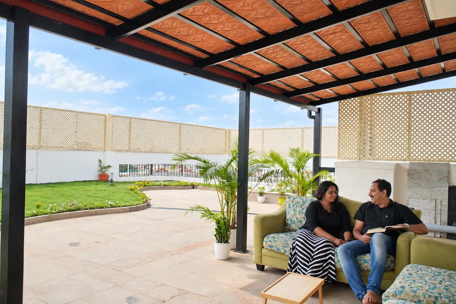 Couple relaxing beneath a Mangalore tile pergola beside a terrace lawn
