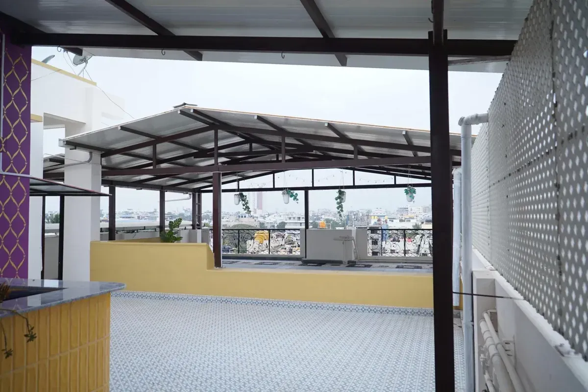A completed rooftop pergola viewed through the adjacent sheltered terrace area