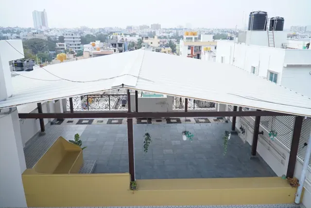 Elevated view of a white PUF roof and the metal-framed terrace beneath